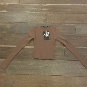 I purchased this top and it’s too small for my frame. Never worn with tags.